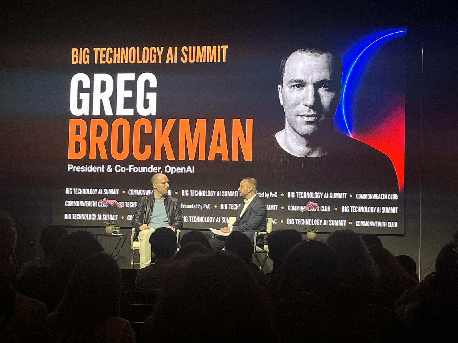 Greg Brockman of OpenAI on the big screen during the closing keynote
